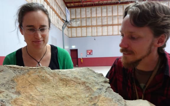 GNS Science palaeobotanist Liz Kennedy and expedition leader Chris Mays, from Monash University, with one of the large, fossil-bearing boulders from the Clarence Valley.