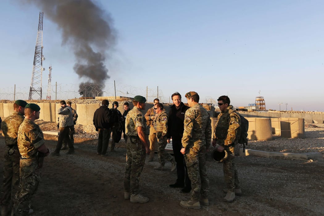 Britain's Prime Minister David Cameron speaks with British soldiers during a visit to Afghanistan in 2012.