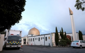 A police vehicle (L) is seen parked by the Al-Noor Mosque ahead of the last day of the sentencing hearing for Brenton Tarrant, the gunman who massacred 51 people during last year's twin mosque attacks, in Christchurch on August 27, 2020.