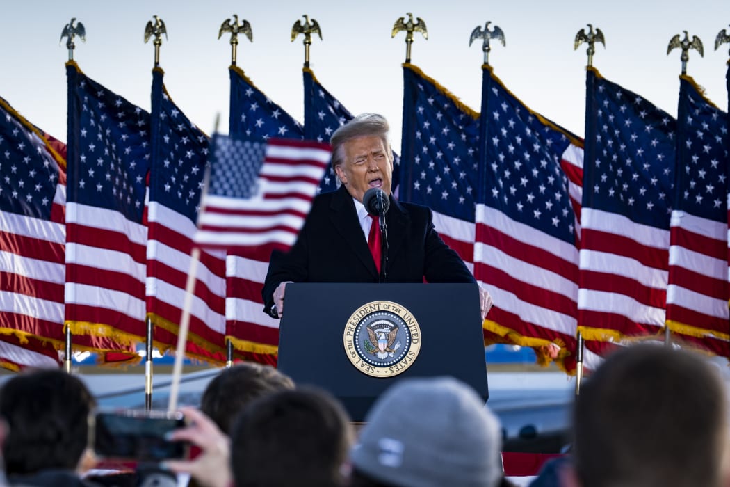 President Donald Trump speaks to supporters at Joint Base Andrews before boarding Air Force One for his last time as President.