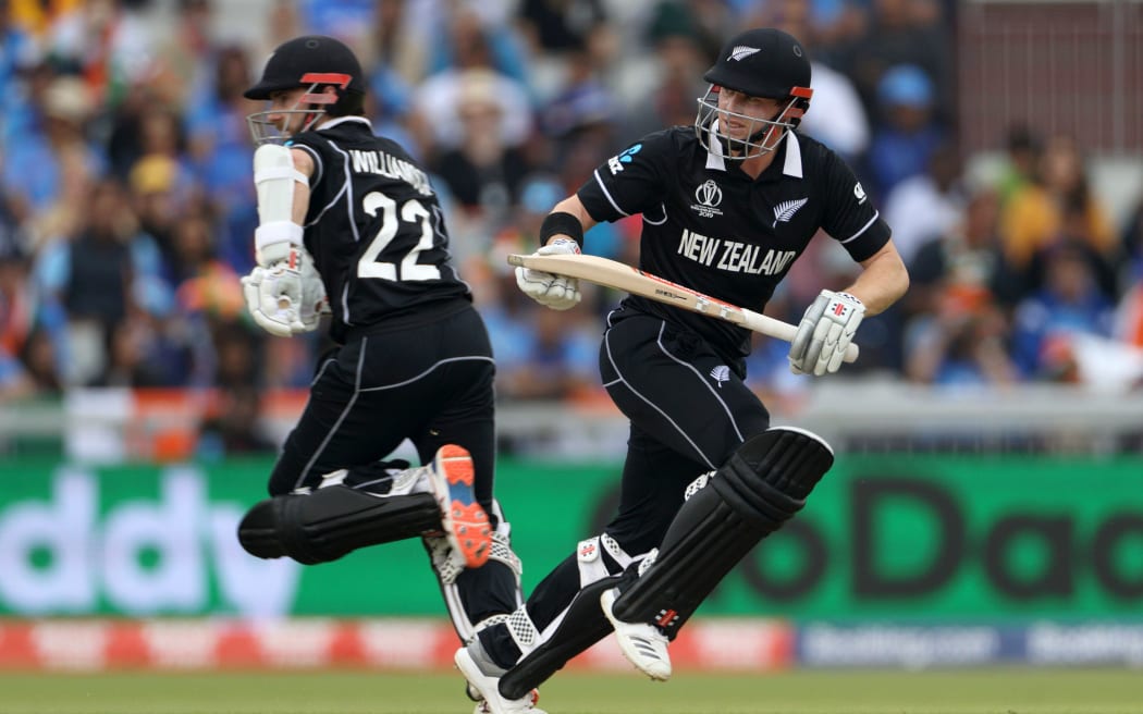 Henry Nicholls runs past Kane Williamson during the Cricket World Cup 2019 semi-final between India and New Zealand at Old Trafford, 2019