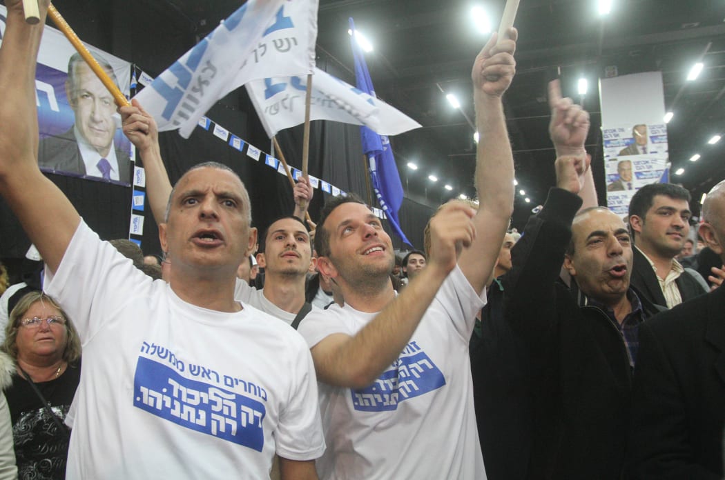 Right-wing Likud supporters celebrate the result.