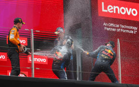 First placed Red Bull Racing's Dutch driver Max Verstappen (1st R), third-placed Red Bull Racing's Mexican driver Sergio Perez (C, front) and second-placed McLaren's British driver Lando Norris (1st L) celebrate on the podium after the Chinese GP, 2024