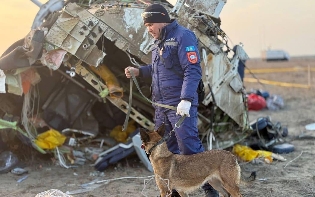 In this handout picture released by Kazakhstan's emergency situations ministry on December 26, 2024, emergency specialists work at the crash site of an Azerbaijan Airlines passenger jet near the western Kazakh city of Aktau. (Photo by Handout / Kazakhstan's emergency situations ministry / AFP) / RESTRICTED TO EDITORIAL USE - MANDATORY CREDIT "AFP PHOTO / KAZAKHSTAN'S EMERGENCY SITUATIONS MINISTRY / HANDOUT" - NO MARKETING NO ADVERTISING CAMPAIGNS - DISTRIBUTED AS A SERVICE TO CLIENTS