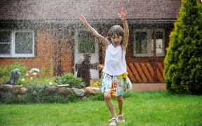 Child in the rain on a summer's day.