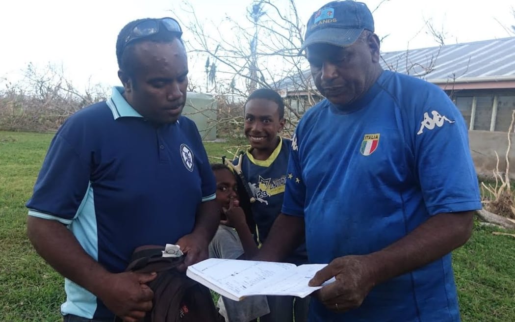 Richard Jenery Senior and Junior look at their community disaster assessment list