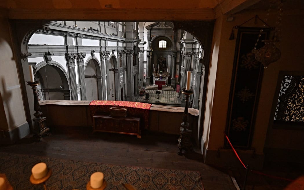 The corridor leads through the church of Santa Felicita, where visitors can peer inside, unseen.