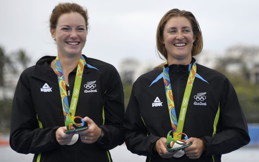 Rebecca Scown and Genevieve Behrent with their medals on the podium of the Women's Pair rowing final at Lagoa stadium in Rio.