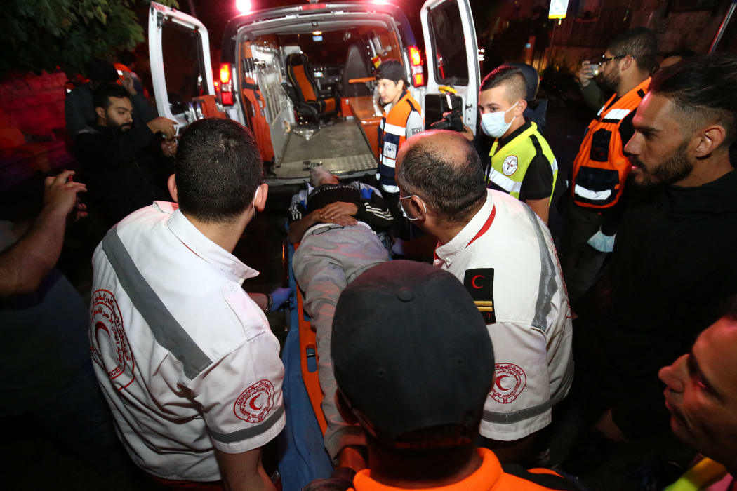 Injured Palestinian Salih Diyab (50) is being carried to an ambulance after Israeli forces' intervention  during a demonstration at Sheikh Jarrah.