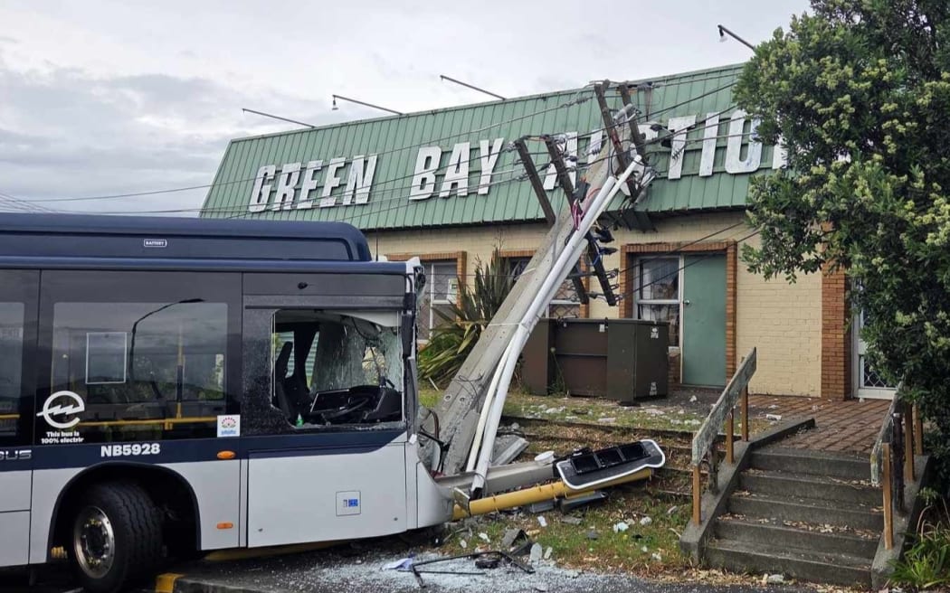 A bus has collided with a power pole in New Lynn, causing damage to Green Bay Auctions.