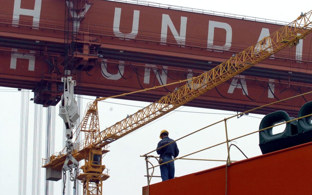 A worker stands at Hyundai Heavy Industries shipyard in Ulsan.