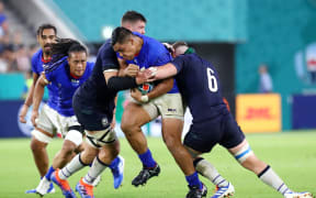 Samoa prop Michael Alaalatoa is tackled by Scotland defenders during their 2019 World Cup pool match in Hyogo, Japan.