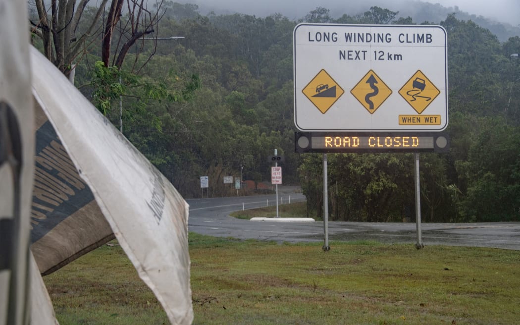 Signage showing a road closure is seen as Cyclone Jasper approaches landfall near Cairns in far north Queensland on December 13, 2023.
