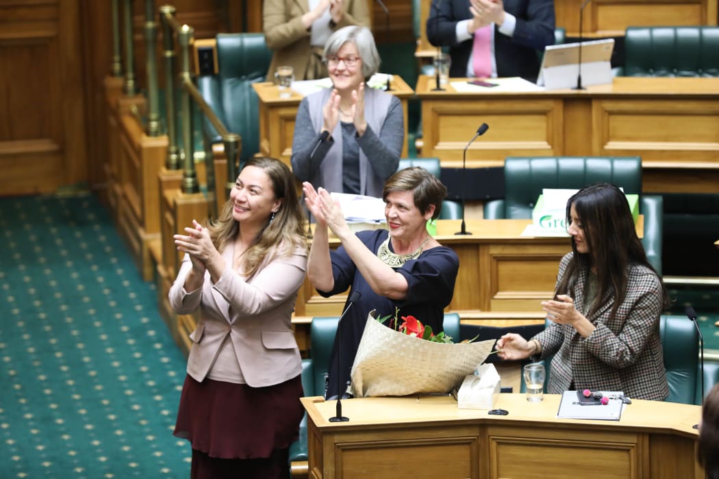 Green MPs Marama Davidson (left), Jan Logie (center) and Golriz Ghahraman  applaud Equal Employment Opportunities Commissioner Jackie Blue after the Domestic Violence Victims Protection Bill passes its third reading.