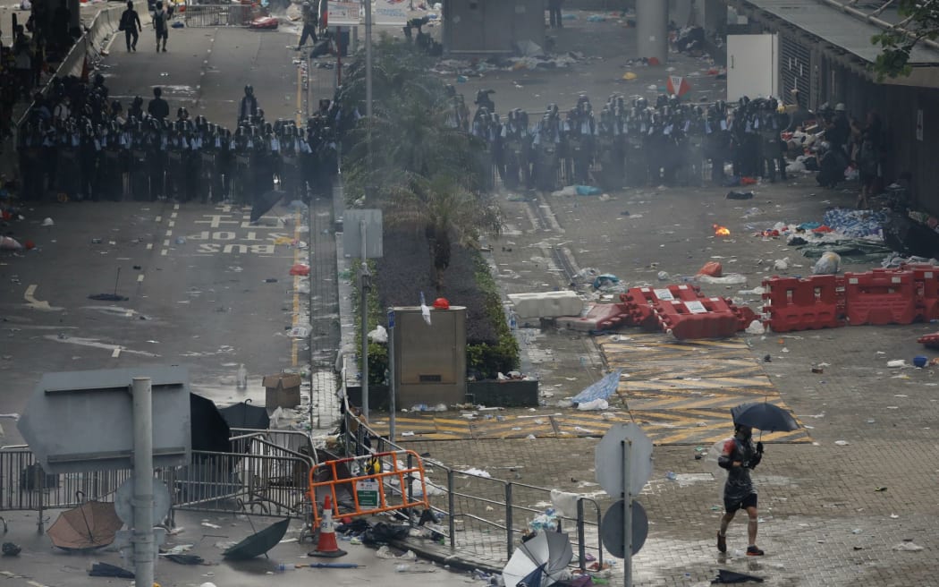 Riot police fire tear gas towards protesters outside the Legislative Council in Hong Kong, Wednesday, June 12, 2019.