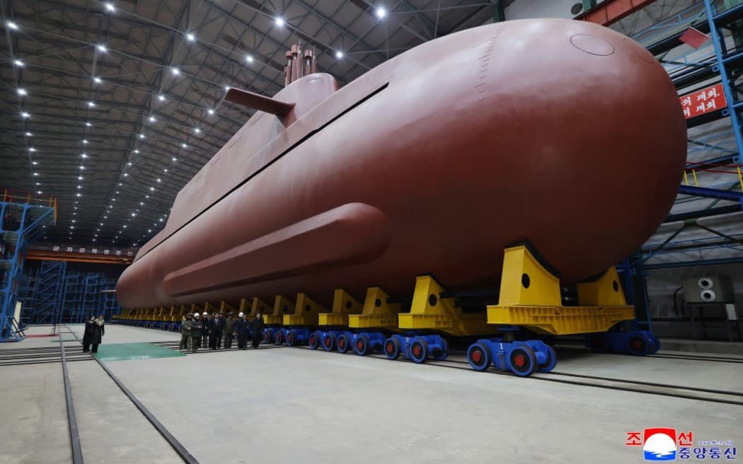 North Korea's leader Kim Jong Un inspected the country's nuclear-powered submarine, claimed to be 8,700 ton, as he called Seoul's nuclear-powered submarine development plan "an offensive act."
