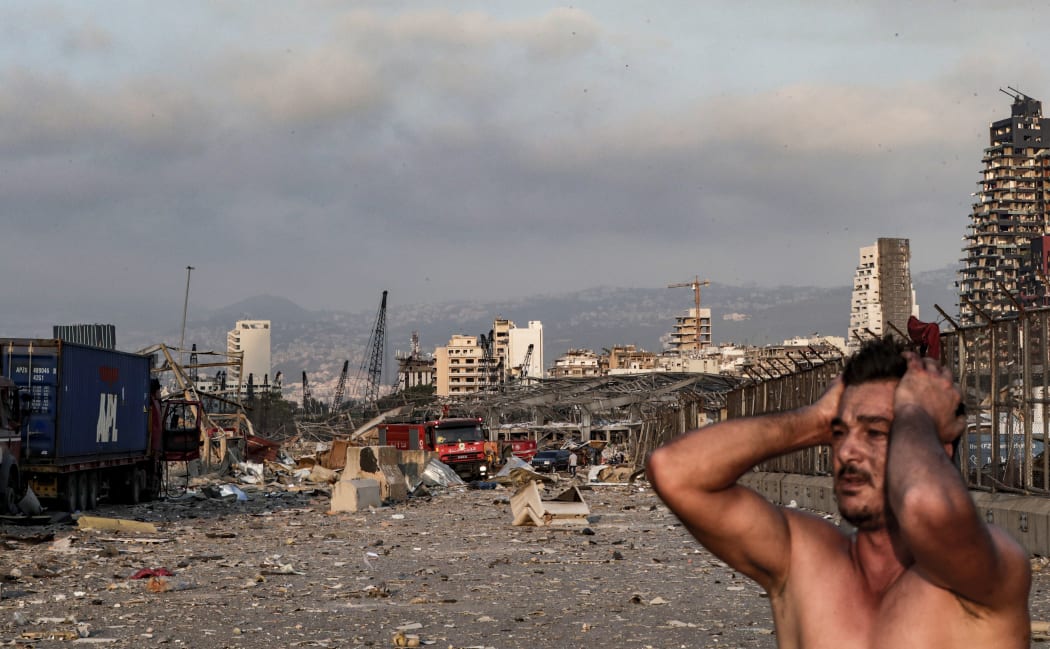 A man reacts at the scene of an explosion at the port in Lebanon's capital Beirut.