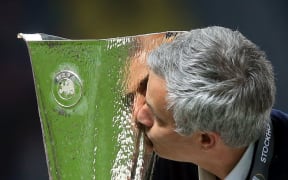 Manchester United manager Jose Mourinho kisses the Europa League trophy.