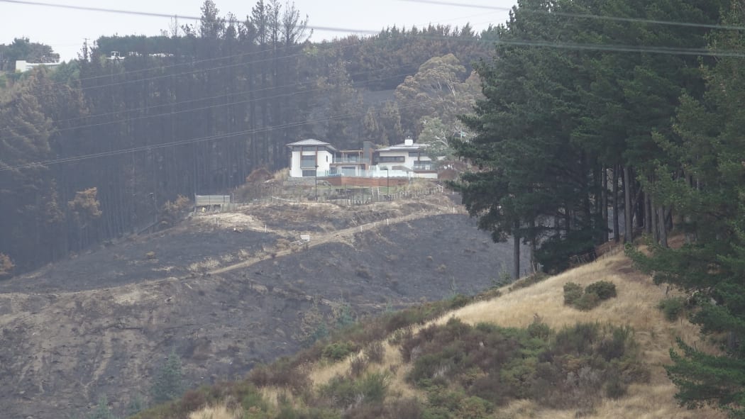 A house on Worsleys Rd, Christchurch surrounded by singed vegetation. Photo taken February 19 2017
