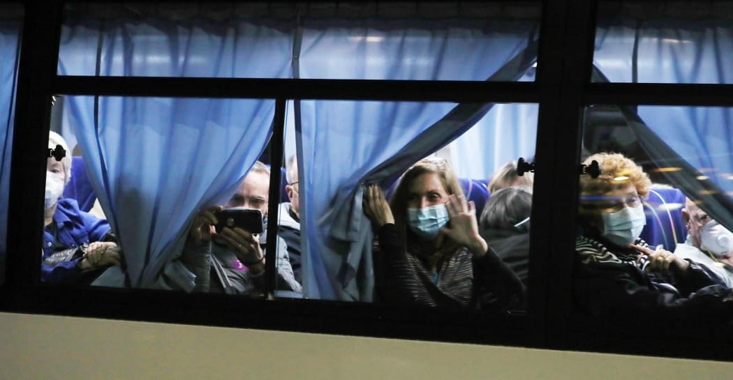 A Japanese defence force bus carries US passengers from Yokoham port to the airport where they will board a charter flight to the United States.