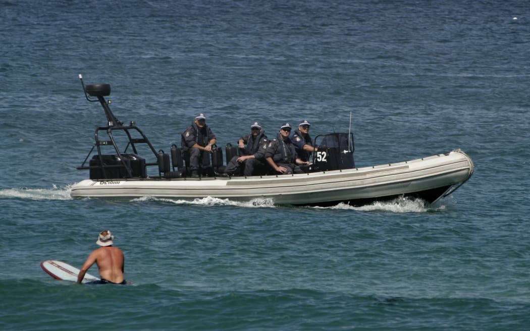 Armed police patrol off Cronulla Beach in after race riots erupted in the Sydney suburb in December 2005.
