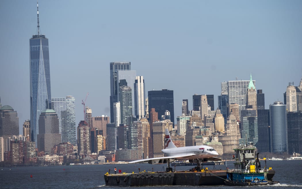 BAYONNE, NEW JERSEY - MARCH 13: A retired British-Airways Concorde supersonic airliner is moved on a barge up the Hudson River on March 13, 2024 seen from Bayonne, New Jersey. The Concorde, one of a fleet of seven once owned by British-Airways, departed the Brooklyn Navy Yard following a months-long restoration project at the GMD Shipyard en route to the Weeks Marine in Jersey City, N.J. for overnight storage before it is returned to the Intrepid Museum.  (Photo by Eduardo Munoz Alvarez/Getty Images)