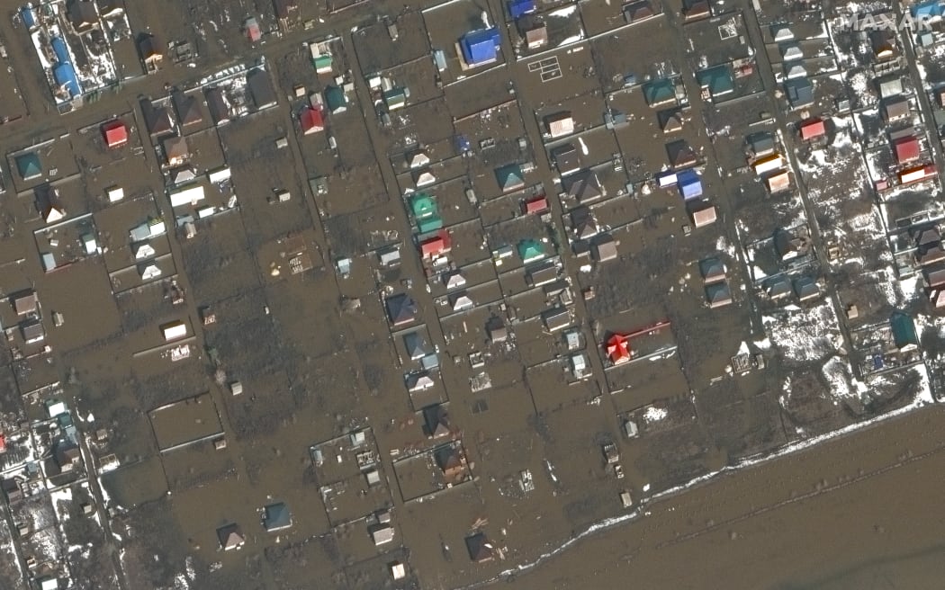 This handout satellite image released by Maxar Technologies on April 10, 2024 shows floodwaters around homes near Orenburg airbase on April 3, 2024. Water levels in overflowing rivers were still rising on April 9 in swathes of Russia and Kazakhstan that have been hit by massive floods, with Russia's city of Orenburg and western Siberia bracing for a new peak. (Photo by Handout / Satellite image ©2024 Maxar Technologies / AFP) / RESTRICTED TO EDITORIAL USE - MANDATORY CREDIT "AFP PHOTO / Satellite image ©2024 Maxar Technologies" - NO MARKETING NO ADVERTISING CAMPAIGNS - DISTRIBUTED AS A SERVICE TO CLIENTS - THE WATERMARK MAY NOT BE REMOVED/CROPPED