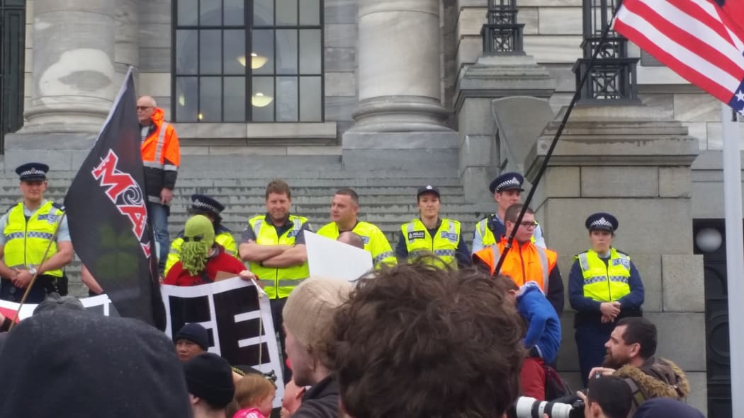 The police continue to hold their line at Parliament against the protesters