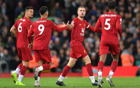Liverpool's English midfielder Jordan Henderson (C) celebrates after scoring during the English Premier League football match between Liverpool and Tottenham Hotspur at Anfield in Liverpool, north west England on October 27, 2019.