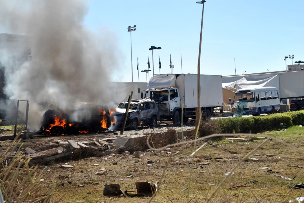 Smoke billows from the site of a suicide car bombing at the defence ministry compound.