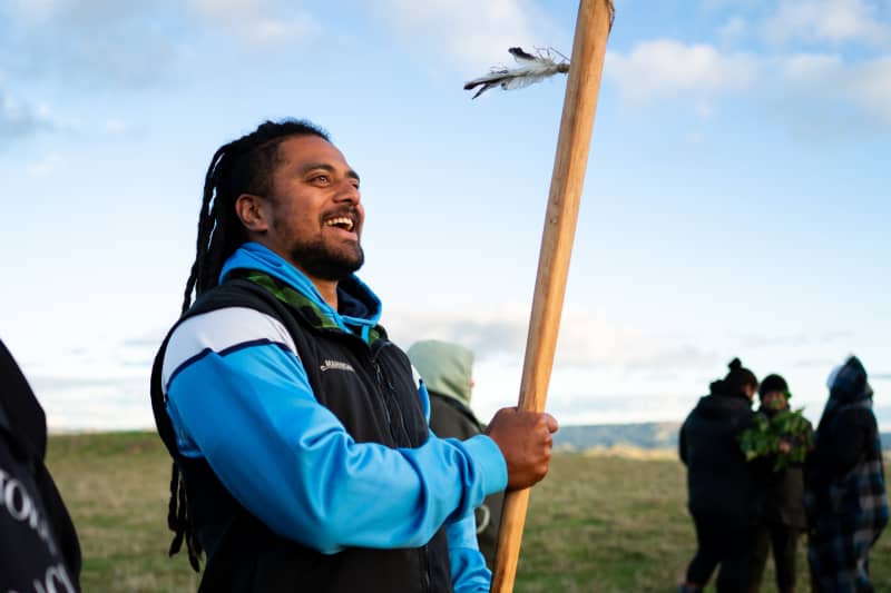 Parekaia Tapiata stands looking into the distance smiling
