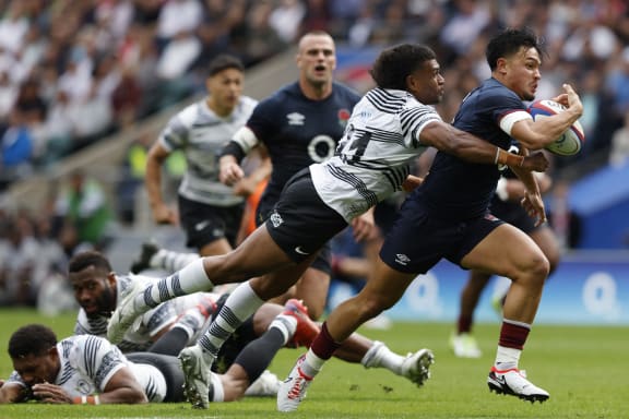 Fiji's Lekima Tagitagivalu tackles England's Marcus Smith during the World Cup warm-up match between England and Fiji at Twickenham Stadium on 26 August.