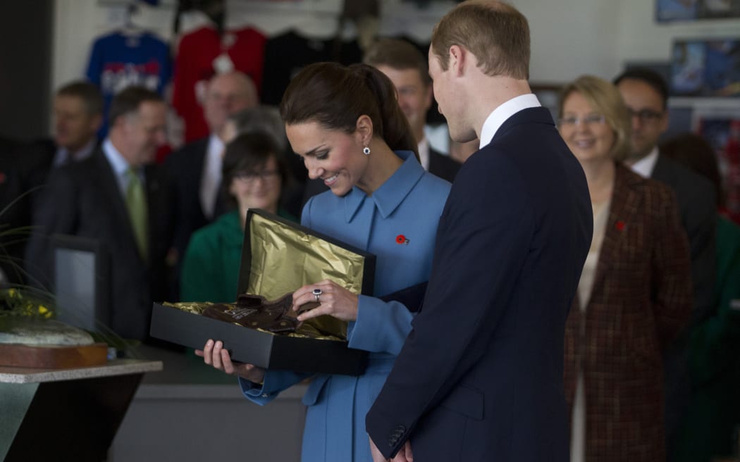 100414 NEWS Photo: IAIN MCGREGOR/FAIRFAXNZ. Pool photos
 Royal Tour of New Zealand.
 The Duke of Cambridge, Prince William and Kate Middleton , Duchess of Cambridge at Omaka Aviation Heritage Centre, Blenheim.
 Kate receives a flying hat for Prince George.