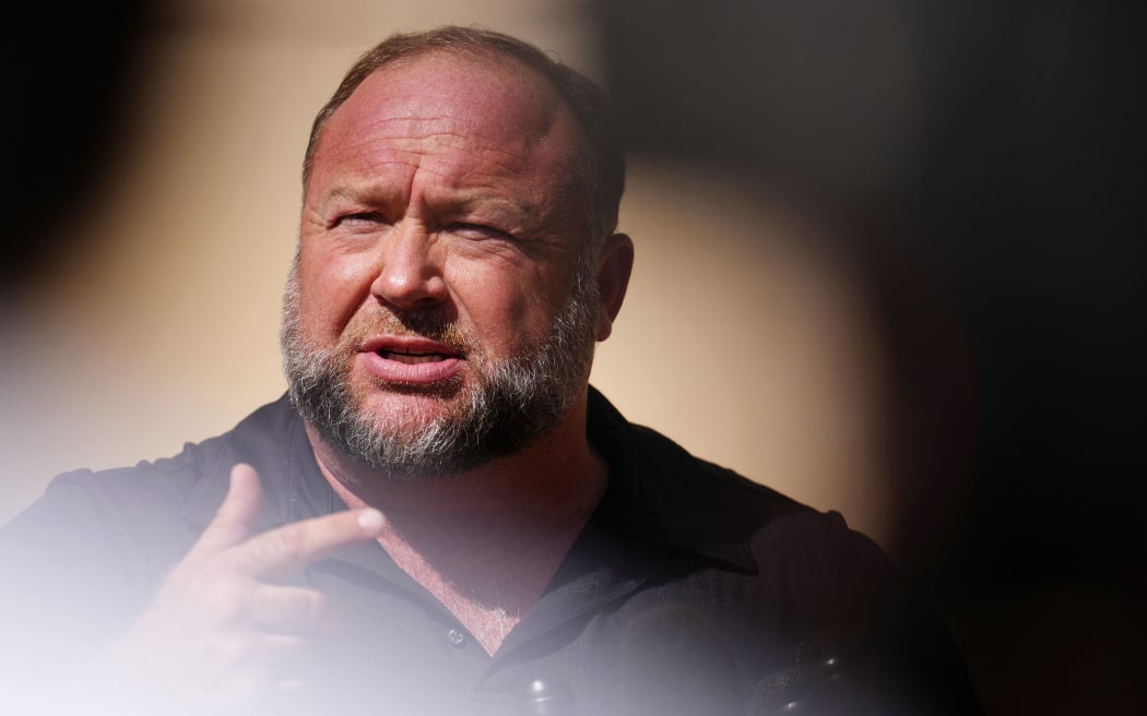 WATERBURY, CONNECTICUT - SEPTEMBER 21: InfoWars founder Alex Jones speaks to the media outside Waterbury Superior Court during his trial on September 21, 2022 in Waterbury, Connecticut. Jones is being sued by several victims' families for causing emotional and psychological harm after they lost their children in the Sandy Hook massacre. A Texas jury last month ordered Jones to pay $49.3 million to the parents of 6-year-old Jesse Lewis, one of 26 students and teachers killed in the shooting in Newtown, Connecticut.   Joe Buglewicz/Getty Images/AFP (Photo by Joe Buglewicz / GETTY IMAGES NORTH AMERICA / Getty Images via AFP)