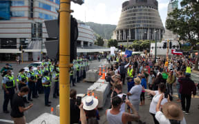 Protestors and Police standoff as police move concrete barricades