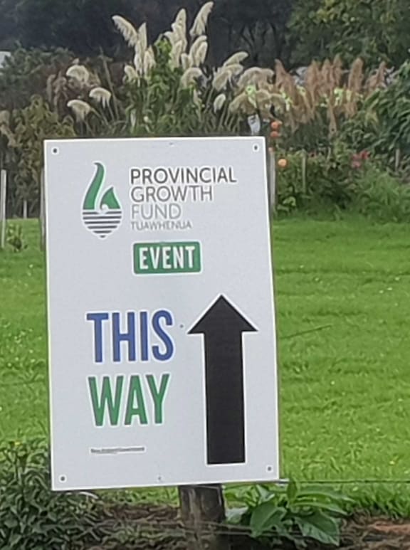 Sign with big arrow pointing to Provincial Growth Fund event
