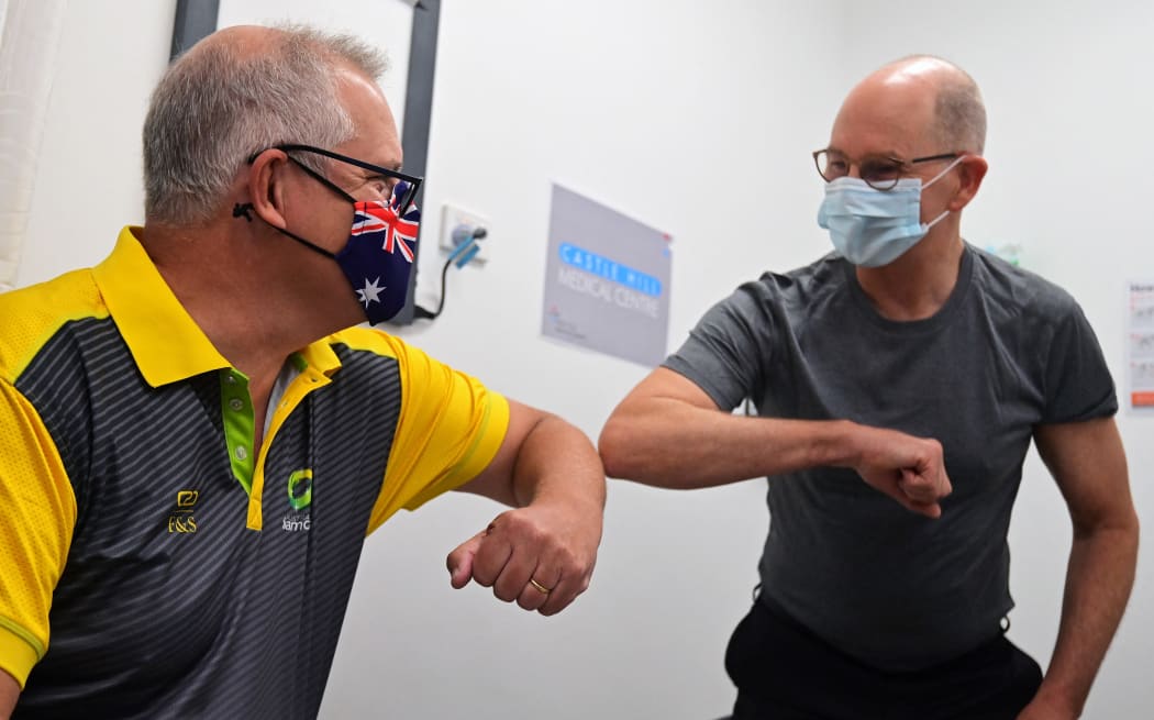 Australia's Prime Minister Scott Morrison (L) bumps elbows with Australian Government Chief Medical Officer Paul Kelly after they both received a dose of the Pfizer/BioNTech Covid-19 vaccine  in Sydney on February 21, 2021.