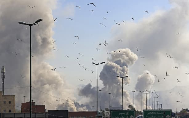 A plume of smoke rises after a strike on the Iranian capital of Tehran on March 5, 2026. Israel pounded Tehran with fresh strikes and Iran targeted Kurdish guerilla groups in Iraq on March 5 as a spiralling war in the Middle East engulfed the entire region. (Photo by Atta KENARE / AFP)
