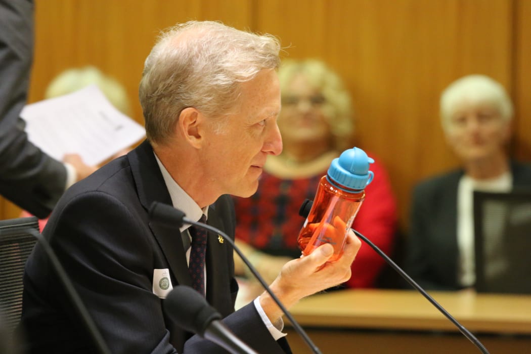Grant Bayldon, Executive Director of Amnesty International NZ, demonstrates the size of a cluster bomblet