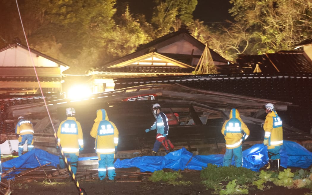 An elderly woman is rescued by firefighters and police officers in Suzu, Ishikawa Prefecture on 6 January, 2024, five days after the massive earthquake occurred.
