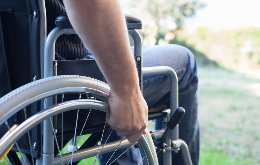 Paralyzed man using his wheelchair