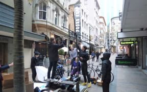 People assemble the Vulcan Lane sculpture (for the first time) before police asked council workers to remove it.