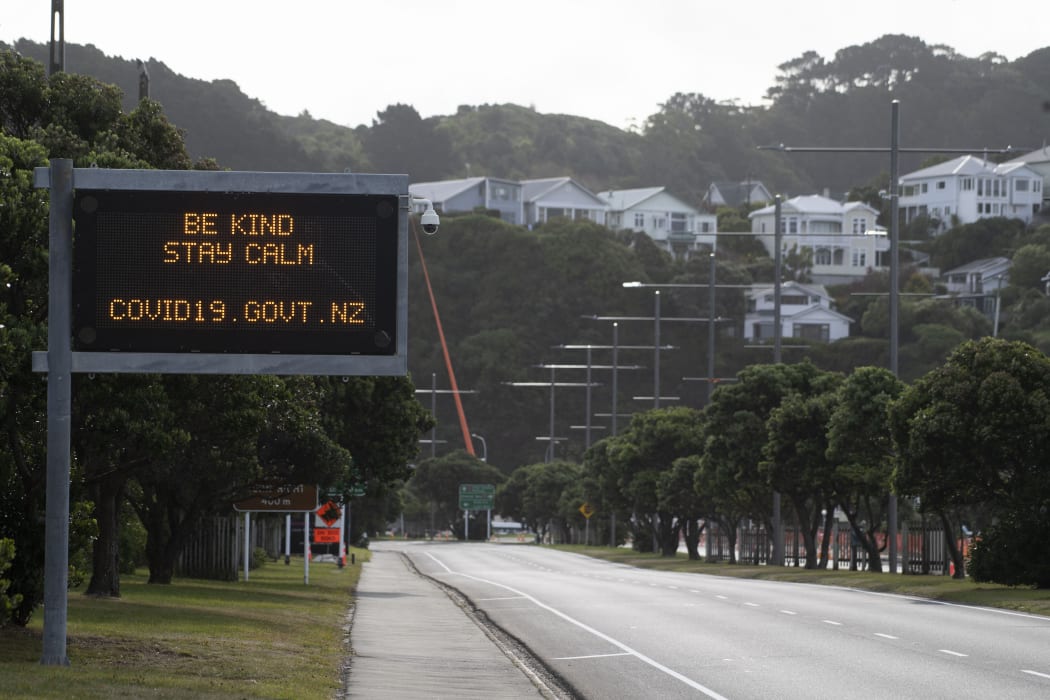 A motorway sign reads "Be kind and stay calm" along a street devoid of cars in response to the COVID-19 coronavirus outbreak in Wellington on April 20, 2020.