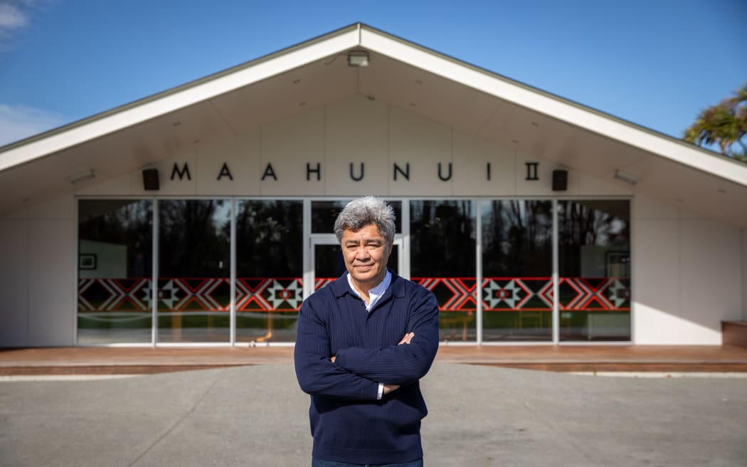 Te Maire Tau standing in front of Tauawhi marae.