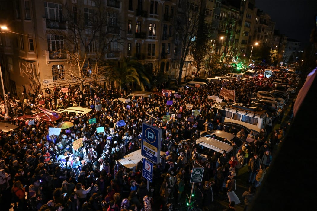 Women chant slogans against police barricades during a rally to mark the International Women's Day in Istanbul, on March 8, 2022.