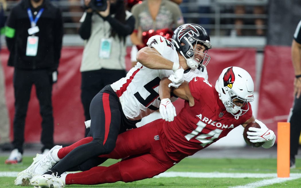 Michael Wilson #14 of the Arizona Cardinals dives forward against the Atlanta Falcons during the third quarter at State Farm Stadium on November 12, 2023 in Glendale, Arizona.