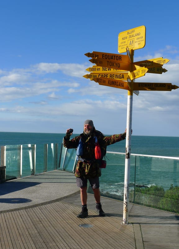 Actor and podcaster Bruce Hopkins reaches Bluff after his 3000-kilometre walk along Te Araroa.