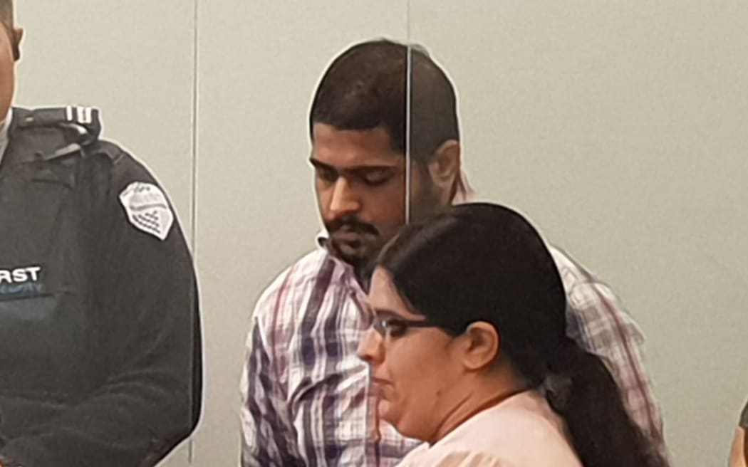 Avneesh Sehgal at his sentencing in the Auckland High Court, with a translator for the court.
