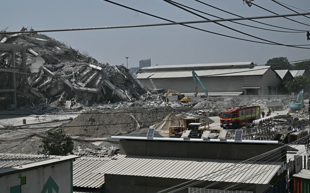 A collapsed building at a construction site is seen in Bangkok on March 28, 2025, after an earthquake. A powerful earthquake rocked central Myanmar on March 28, buckling roads in capital Naypyidaw, damaging buildings and forcing people to flee into the streets in neighbouring Thailand. (Photo by Lillian SUWANRUMPHA / AFP)