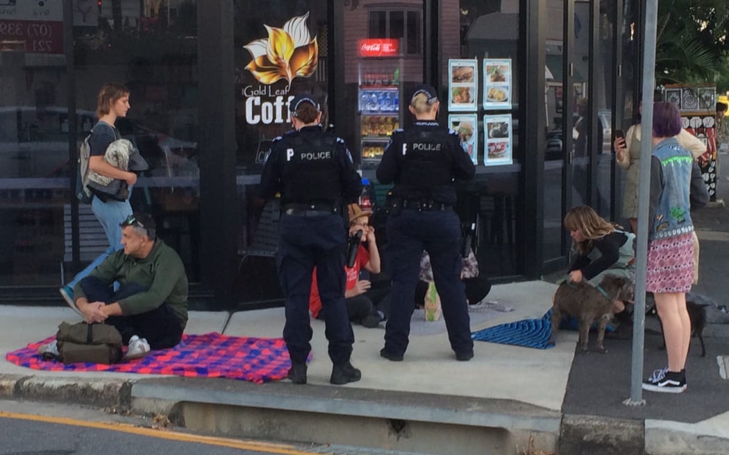 Police fine protesters outside the Brisbane APOD.